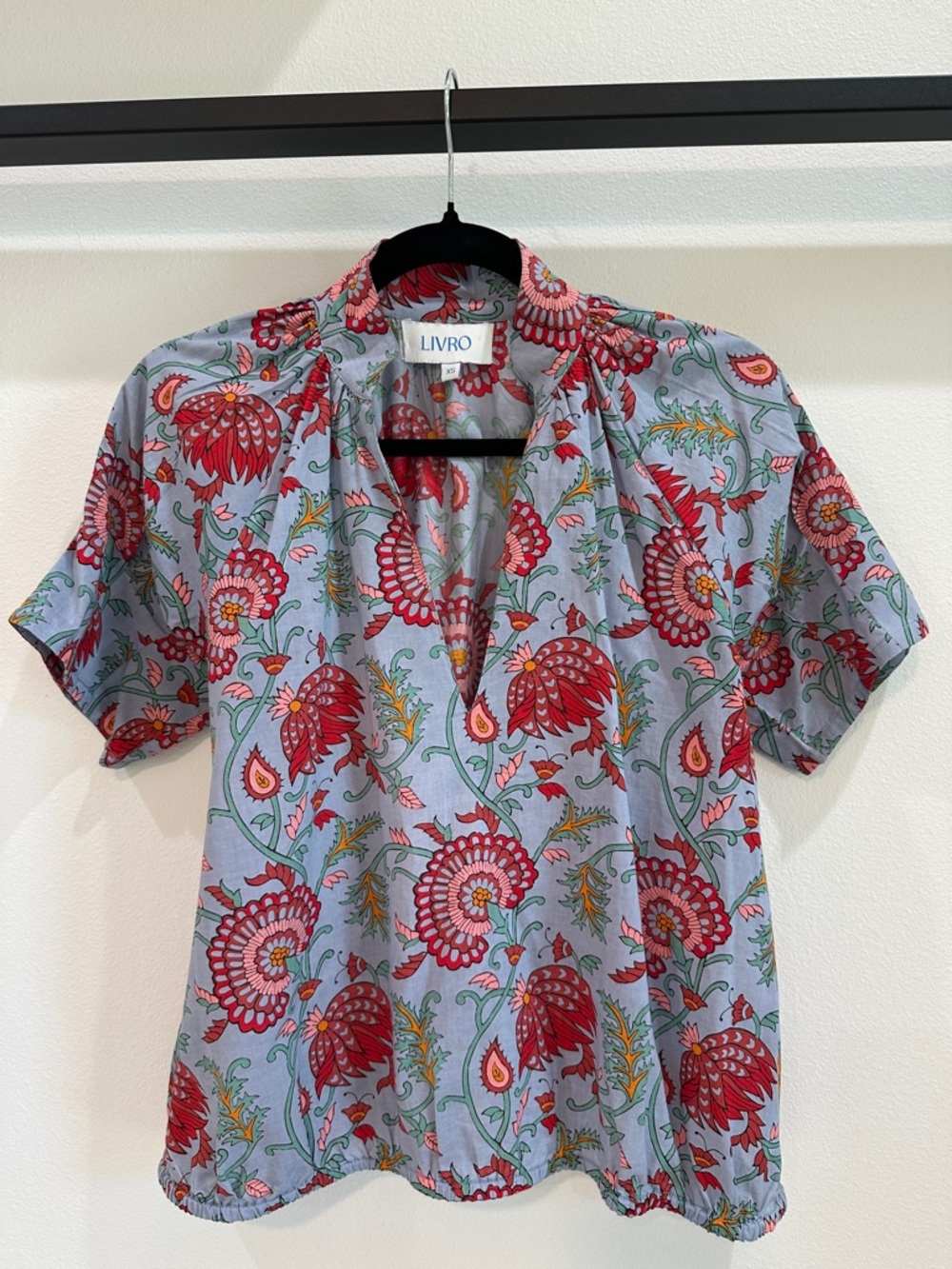 LIVRO dusty blue top with reds, sage, pink & orange florals. Plunging neckline.
